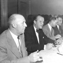 Men seated at table of honor during Farmer's Night Banquet.